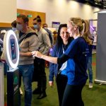 Guests interact with Presto photo booth at a corporate tradeshow
