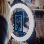 Two guests using a Presto booth with digital overlay display