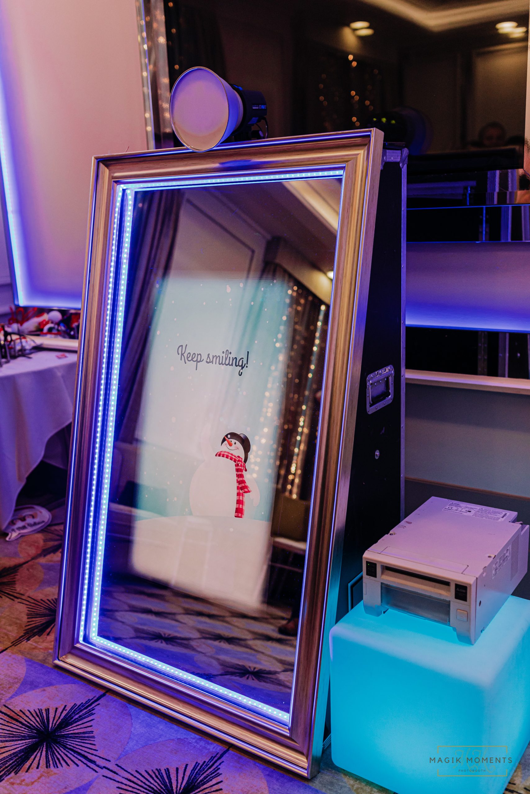 Magik Mirror Photo Booth with winter-themed digital display and holiday decor